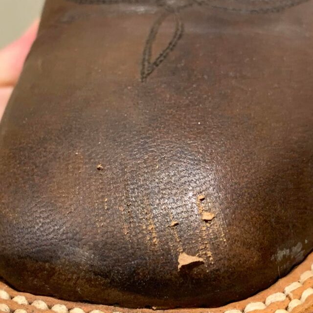 Peeling leather on boots.
