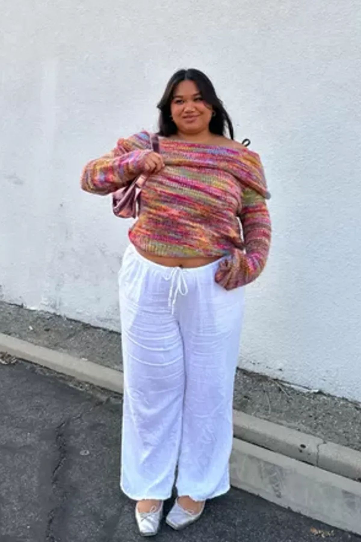 Multicolored top, white wide-leg pants, subtle accessories, casual and stylish aesthetic.