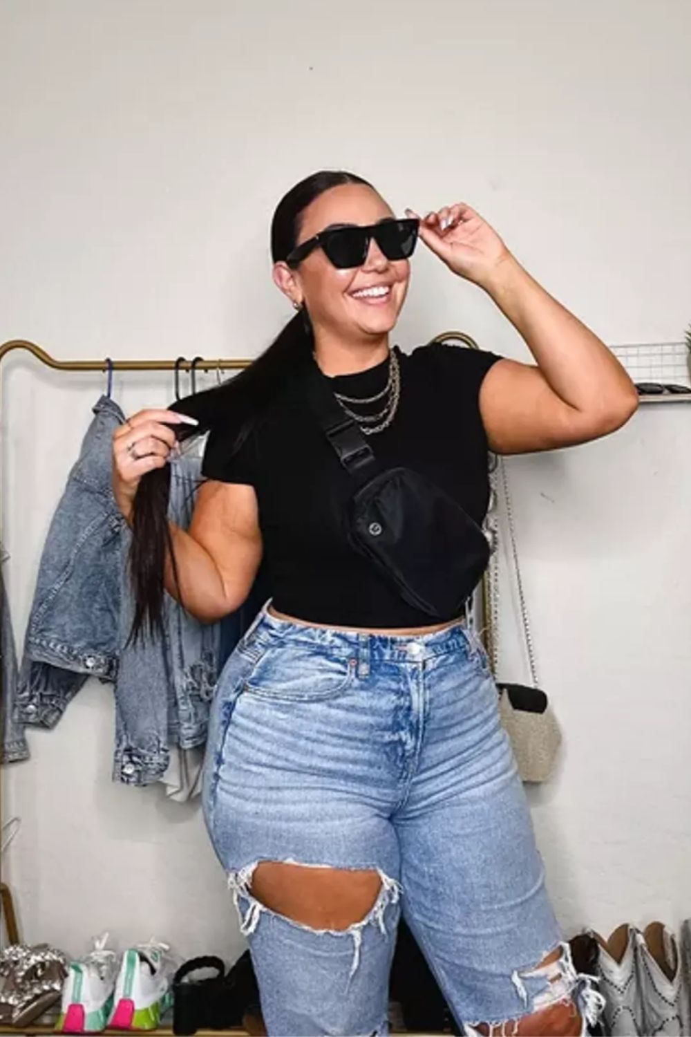 Light-wash jeans, black top, oversized sunglasses, chain necklace for urban chic.