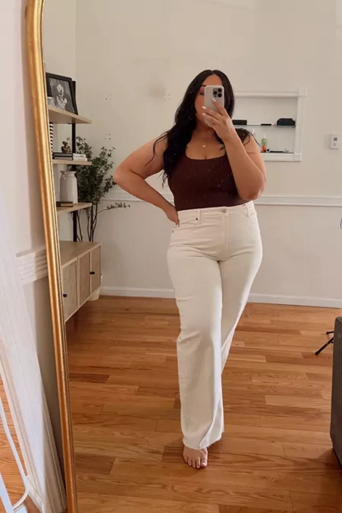 High-waisted trousers, fitted brown top, warm, complementary contrast.