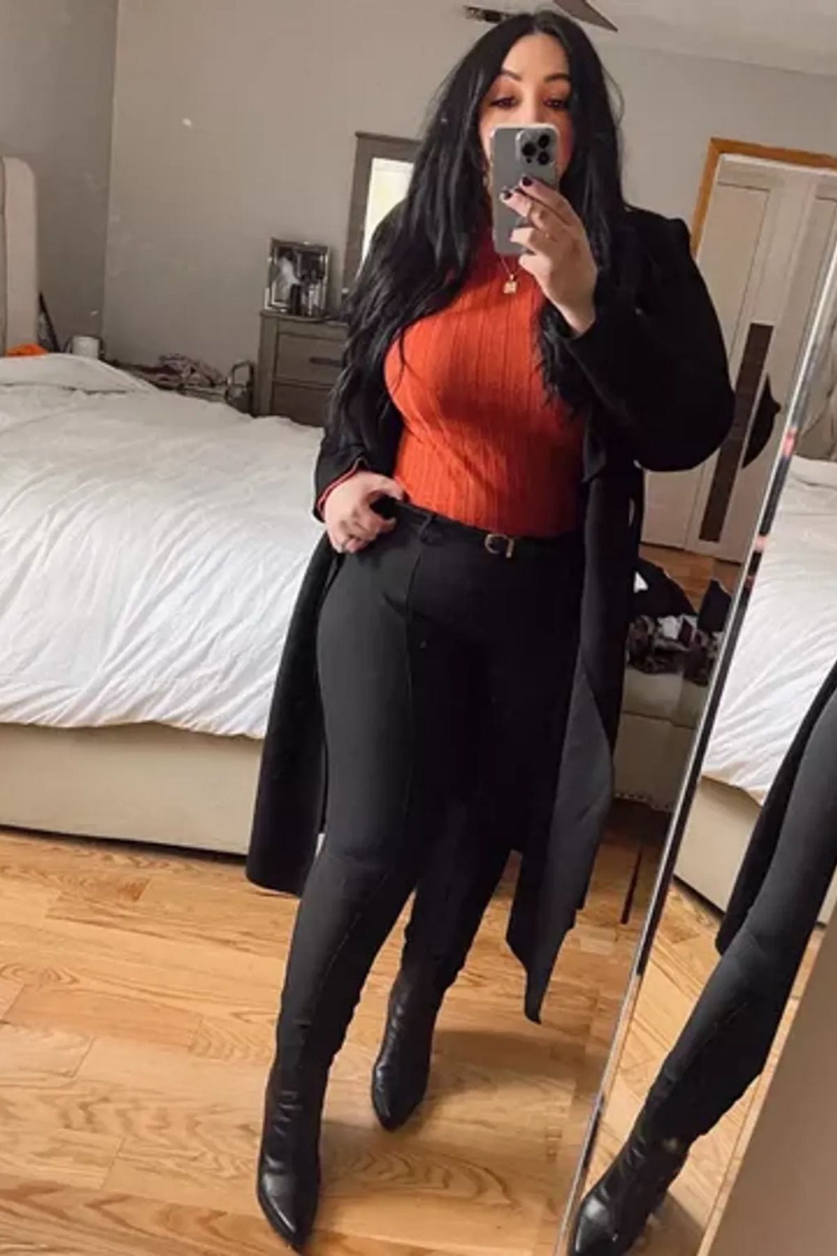 Vibrant orange top, high-waisted pants, tailored silhouette.