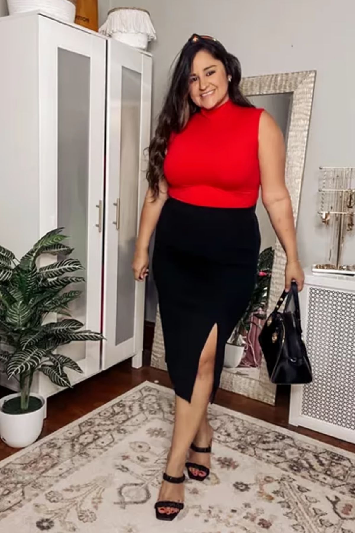 Bold red top, high-waisted black skirt with a slit, black accessories.